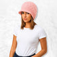 Une femme porte le Bonnet Casquette Femme Rose porté